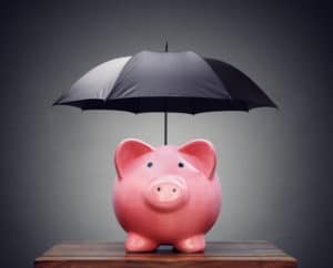 Image of a pink piggy bank with an umbrella covering it for rainy days