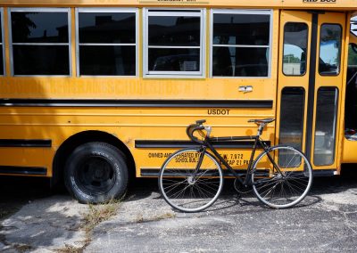 Image of a school bus with a bicycle leaning against it