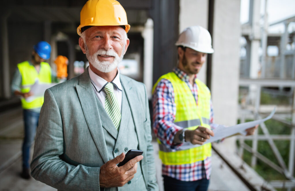Image of Confident team of architects and engineers working together on modern construction site