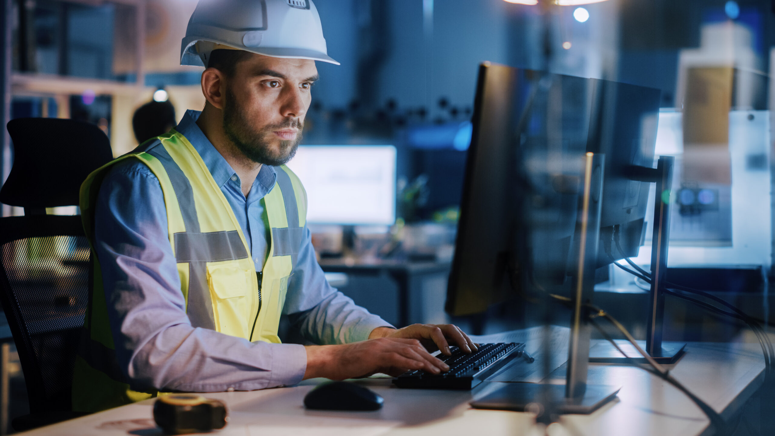 Image of a construction worker at a computer