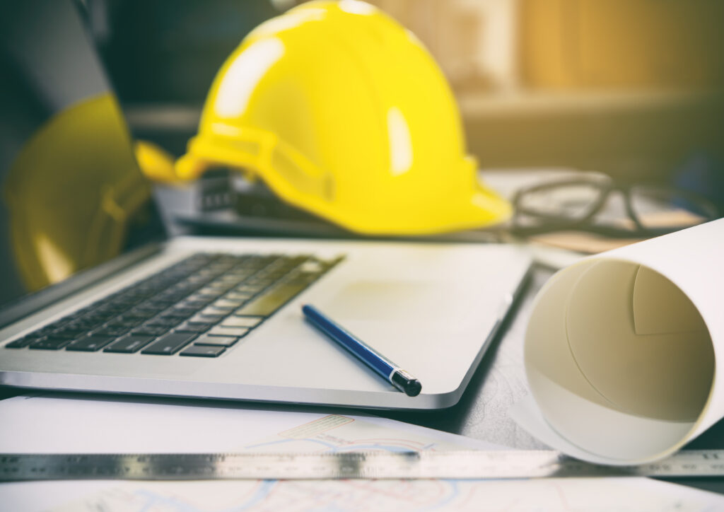 Image of construction office desk with computer and tools