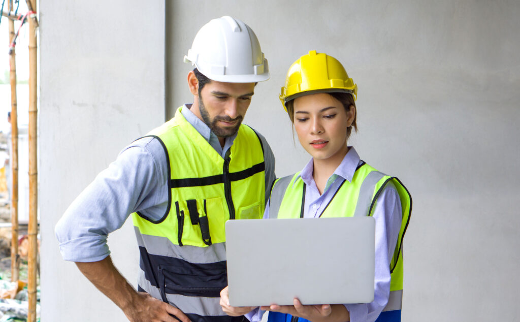 Image of a man and woman reviewing their construction budget with a construction project management app