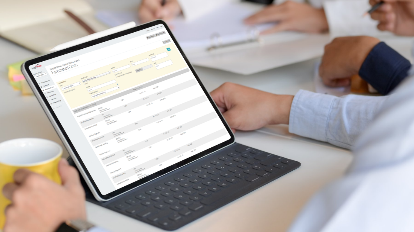 Image of two construction workers watching a crane while evaluating blue prints